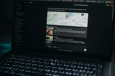 Laptop screen shows a map and related information.